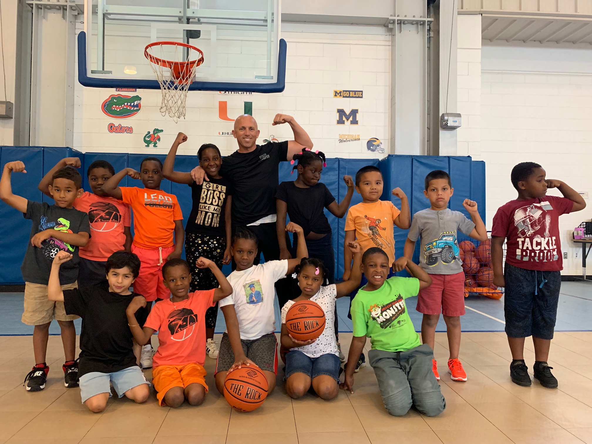 Lt. Greg Bueno posing with a group of youth from the Boys & Girls Clubs of Collier County