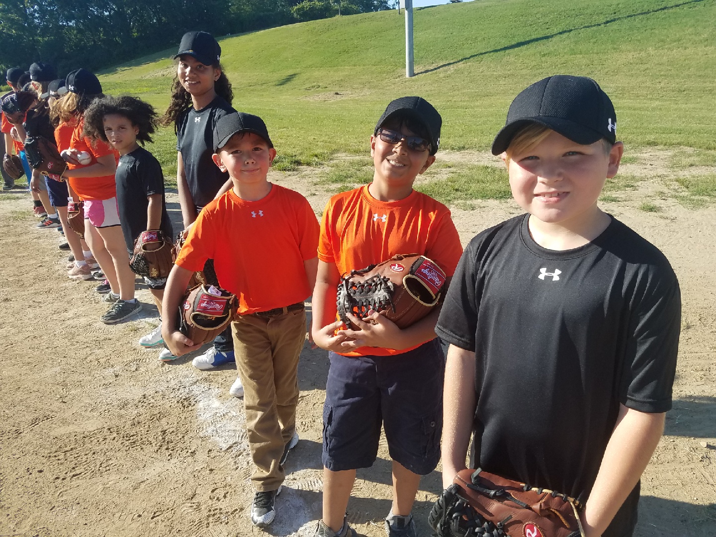 Youth posing with the equipment they received from participating in the Cal Ripken, Sr. Foundation Instructional Leagues