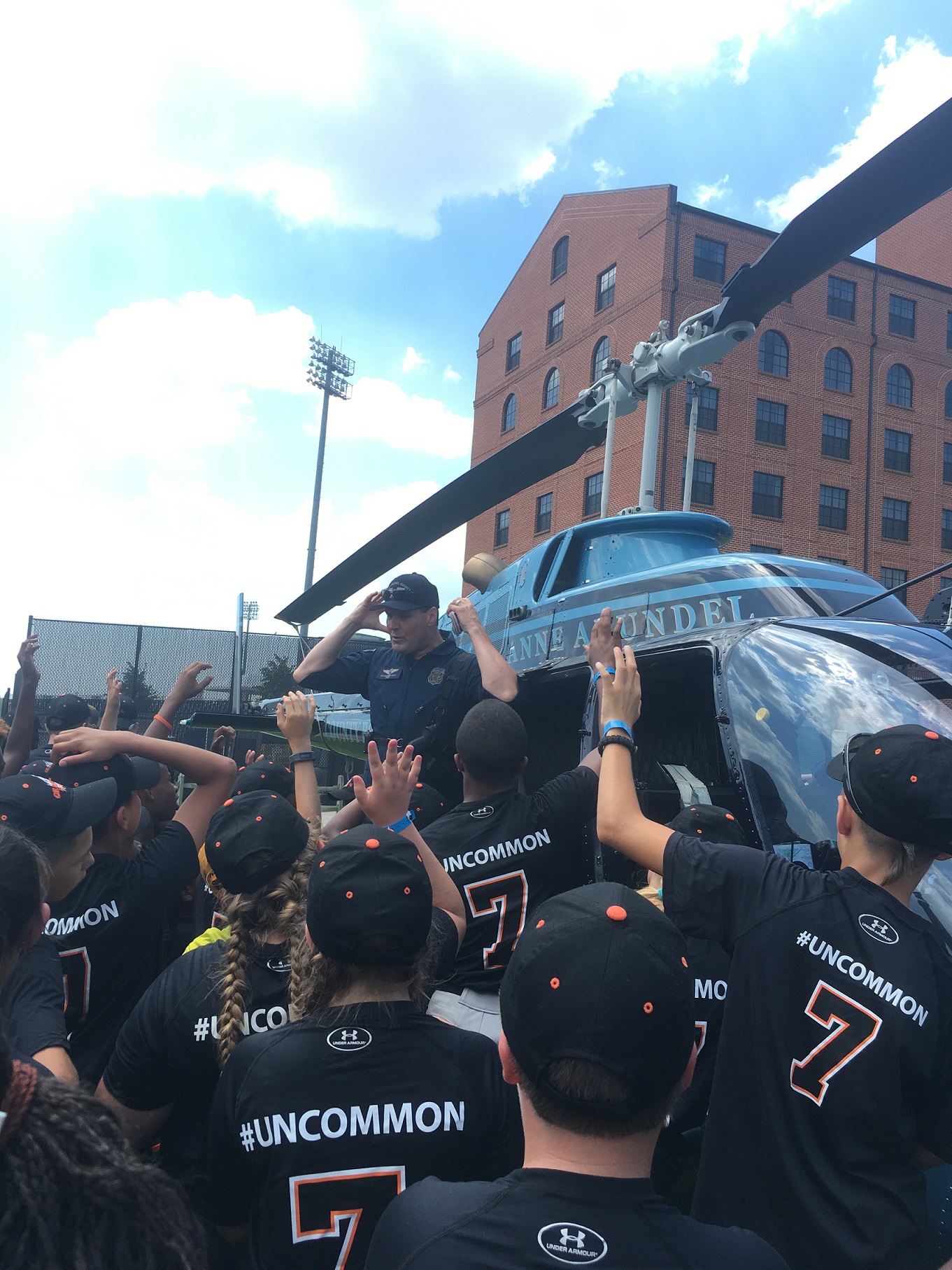 Youth with a police officer showing off a helicopter