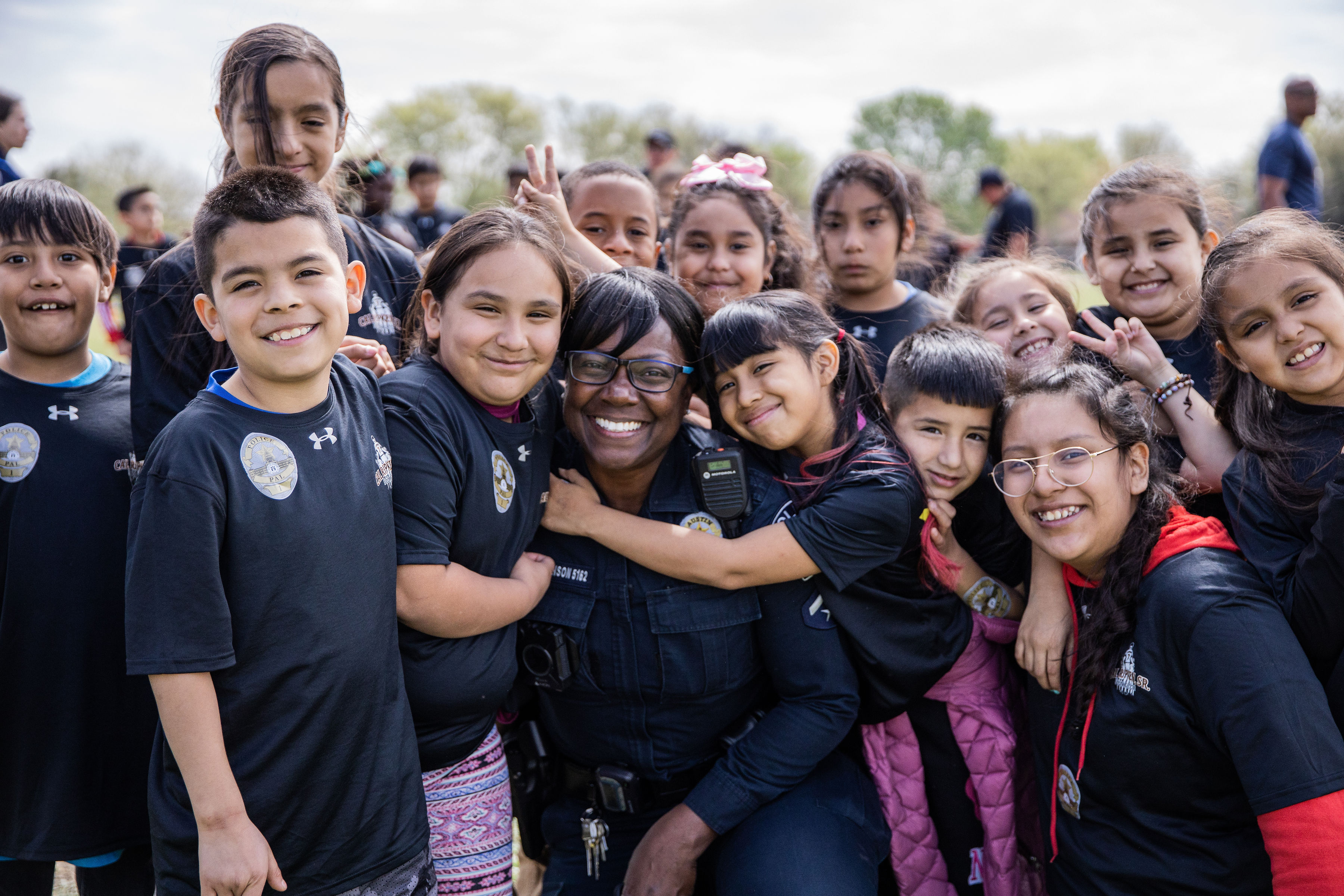 An Austin Police Officer with several Badges for Baseball Youth