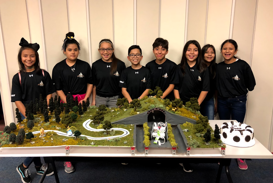 SpringSpirit youth with their winning STEM Competition entry prototype of an ecosystem with a highway running through it.