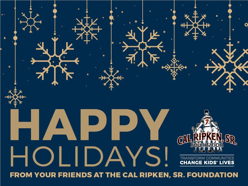 A picture of our holiday card with gold snowflakes on a blue background with the text "Happy Holidays"