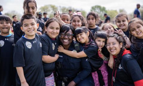 An Austin Police Officer with several Badges for Baseball Youth