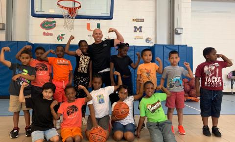 Lt. Greg Bueno posing with a group of youth from the Boys & Girls Clubs of Collier County