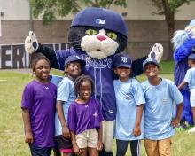 Tampa Badges youth posing with mascot